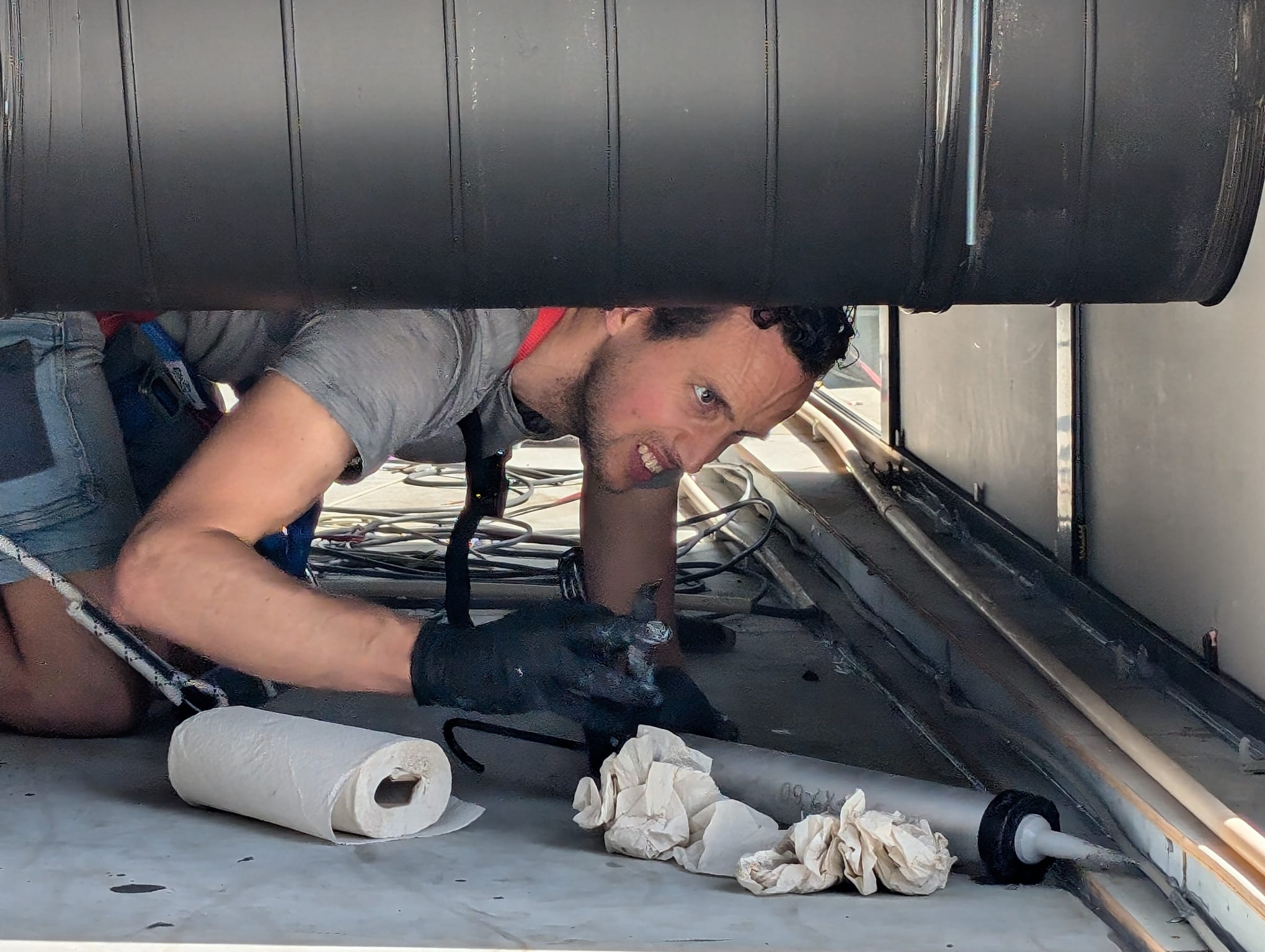 Technician closing gaps under equipment